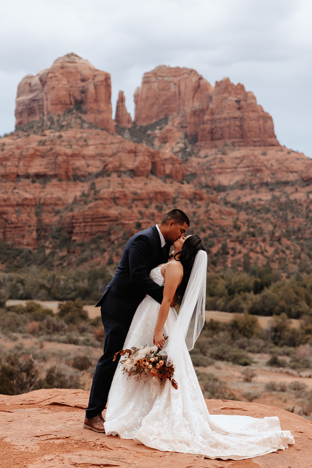A couple who eloped in sedona dip in front of Cathedral Rock
