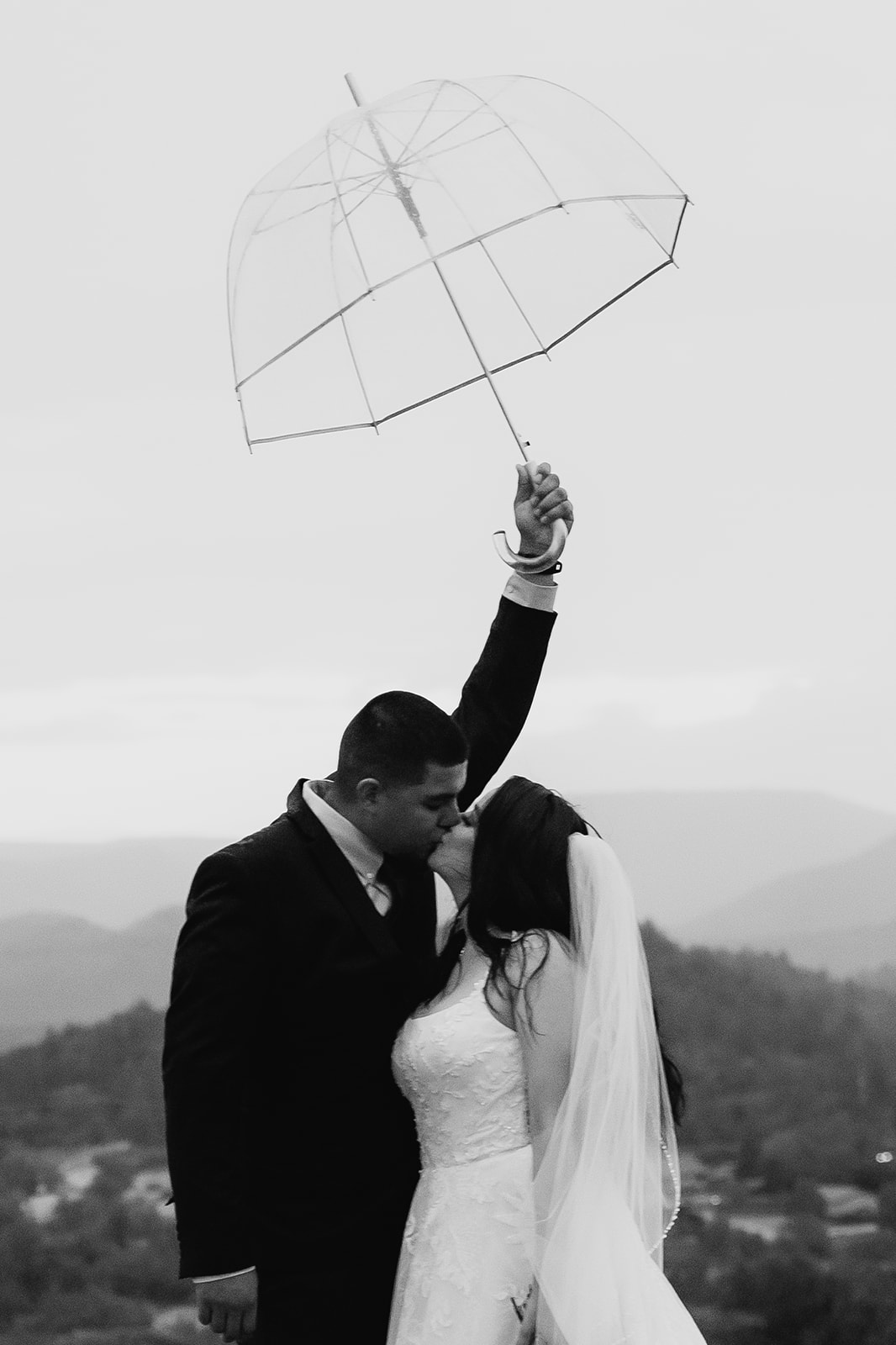 A couple who eloped in sedona kiss in the rain