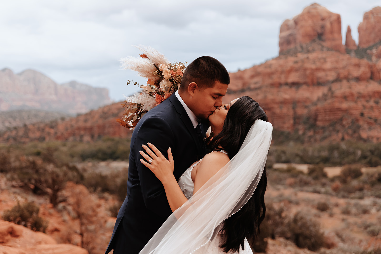 A couple who eloped in sedona kissing