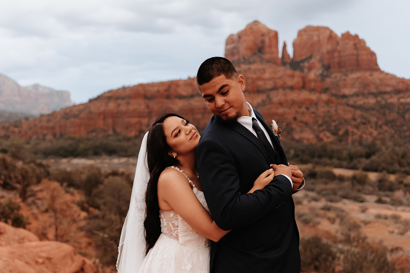 A couple who eloped in sedona pose for portraits