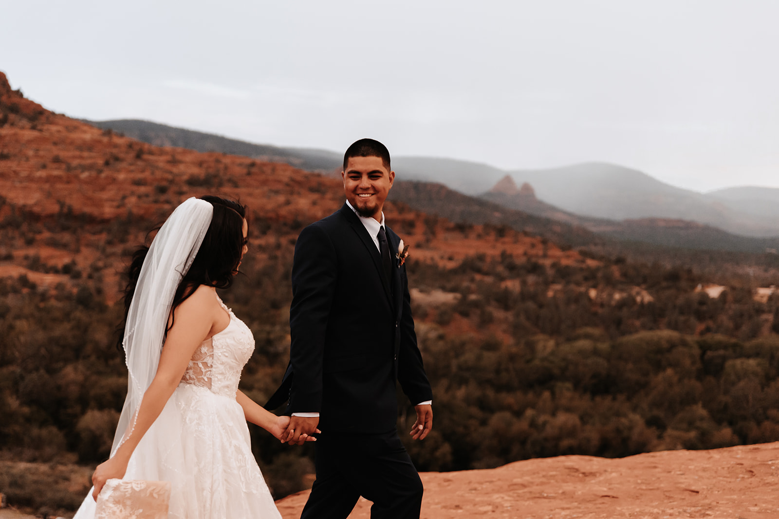 A couple who eloped in sedona walking in the rain