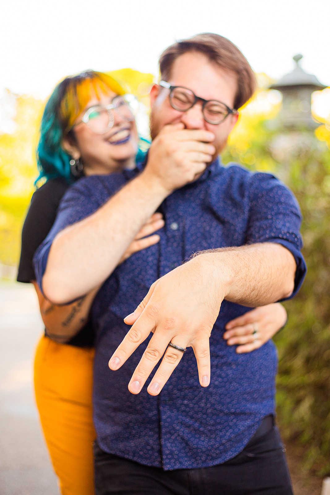 queer couple showing off engagement ring