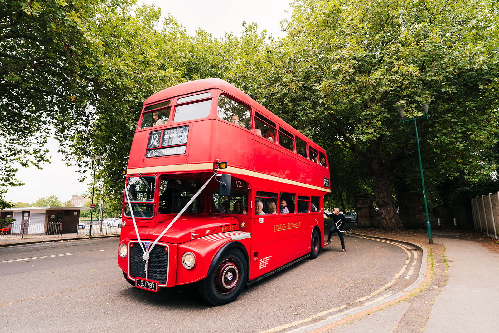 The Brewhouse & Kitchen Wedding Photography - the wedding guests arriving in a big red London bus