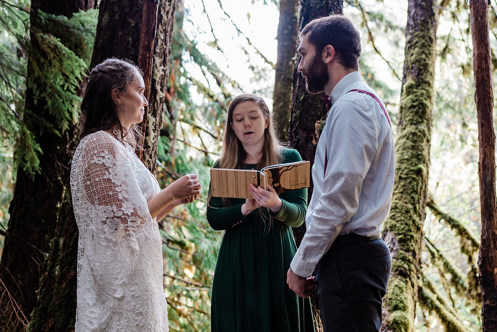 This is a picture taken during an elopement ceremony. It is the bride and groom and officiant. 