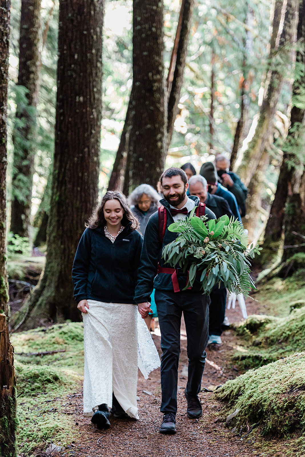 This is a picture of a small crew walking to an elopement ceremony.