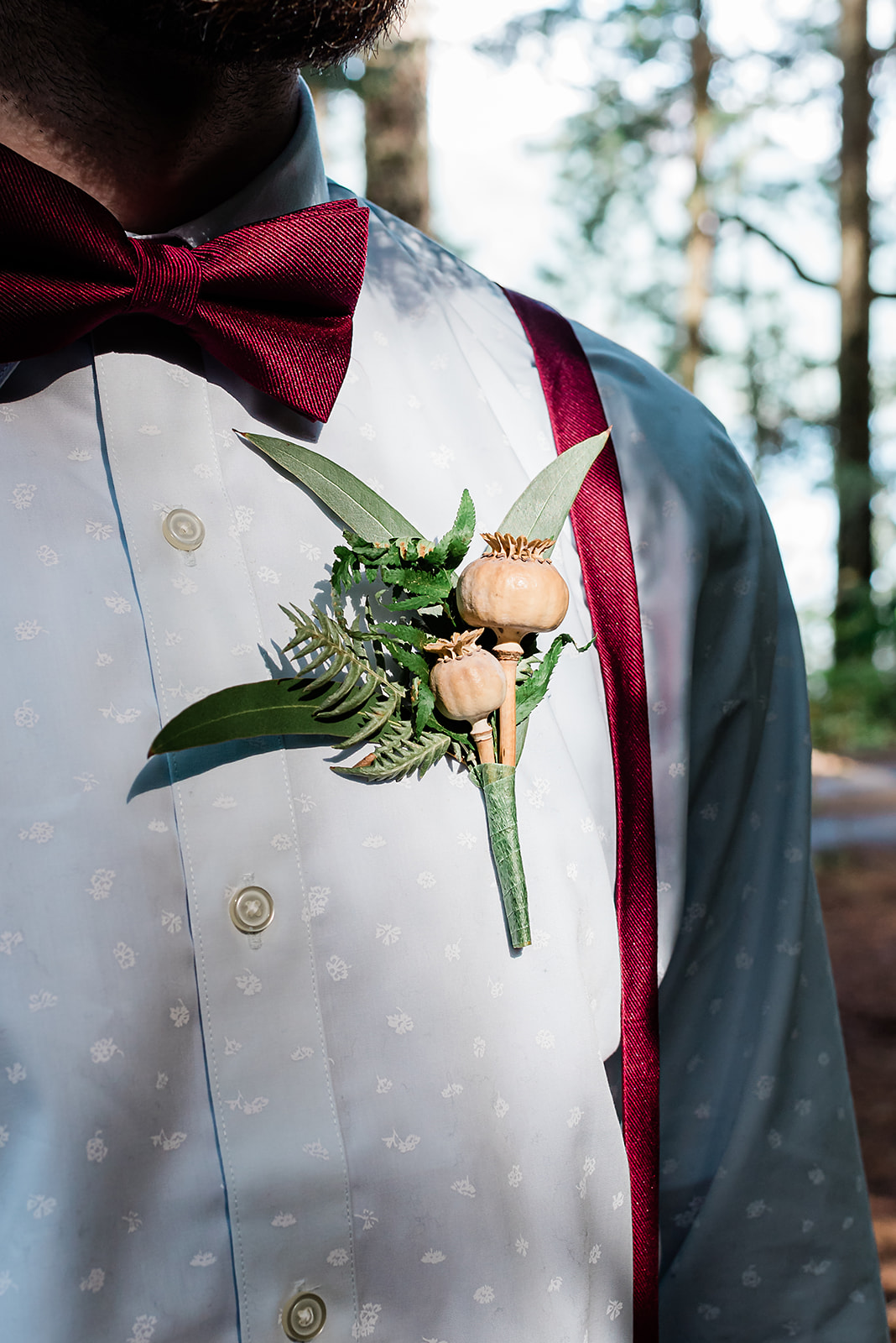 This is a close-up of a groom and his florals. 