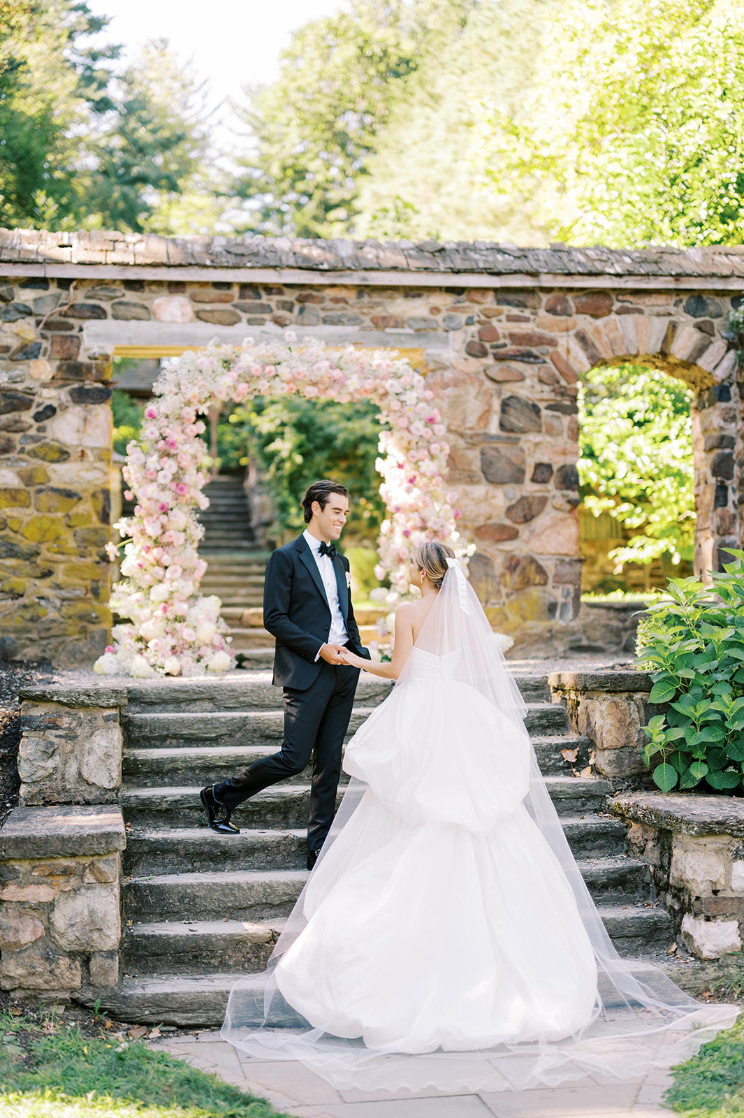 bride and groom on stone steps at Timeless Summer Wedding at Parque at Historic Hunting Hill Mansion