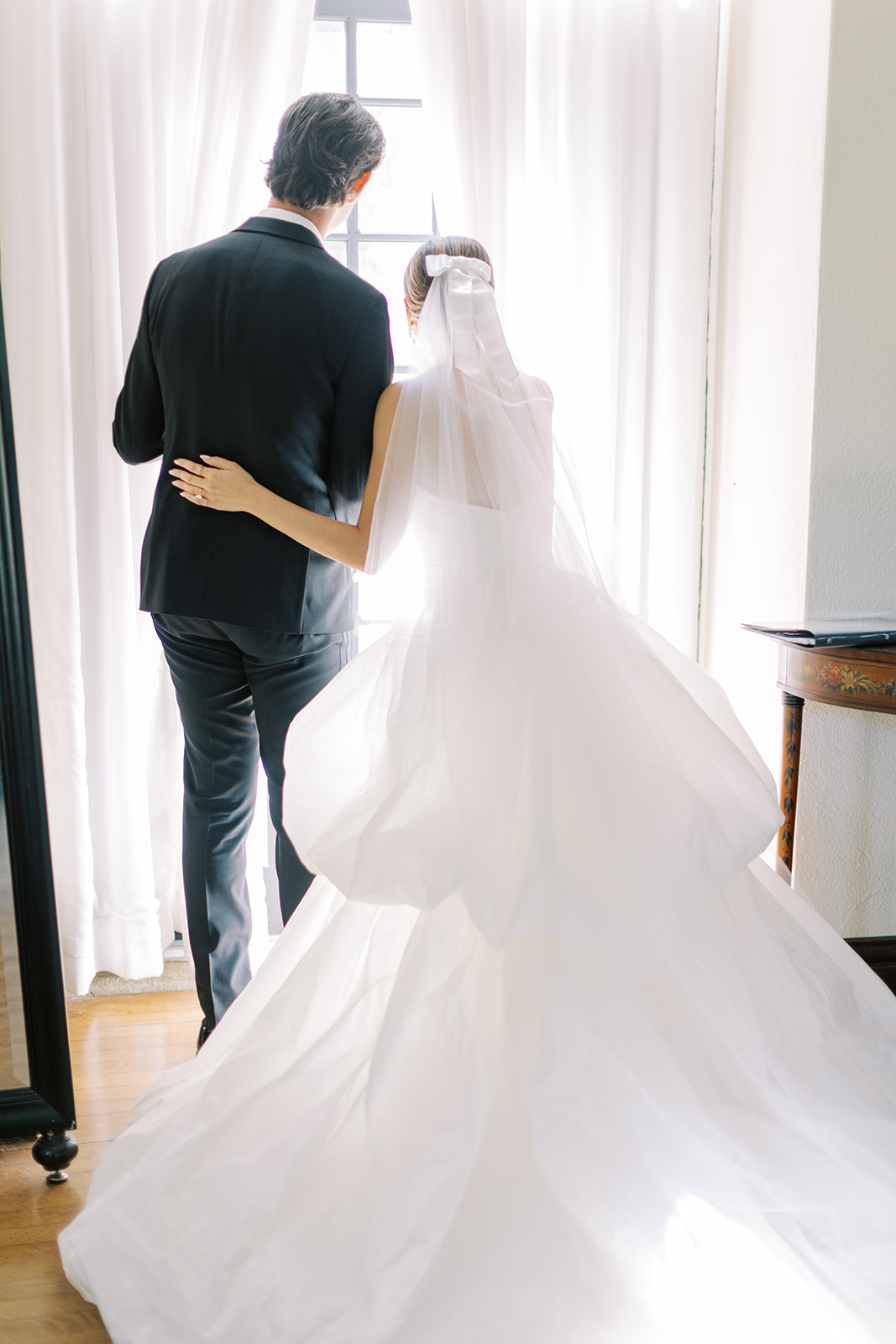 bride and groom peek through the window in intimate moment for Timeless Wedding at Parque Historic Hunting Hill Mansion