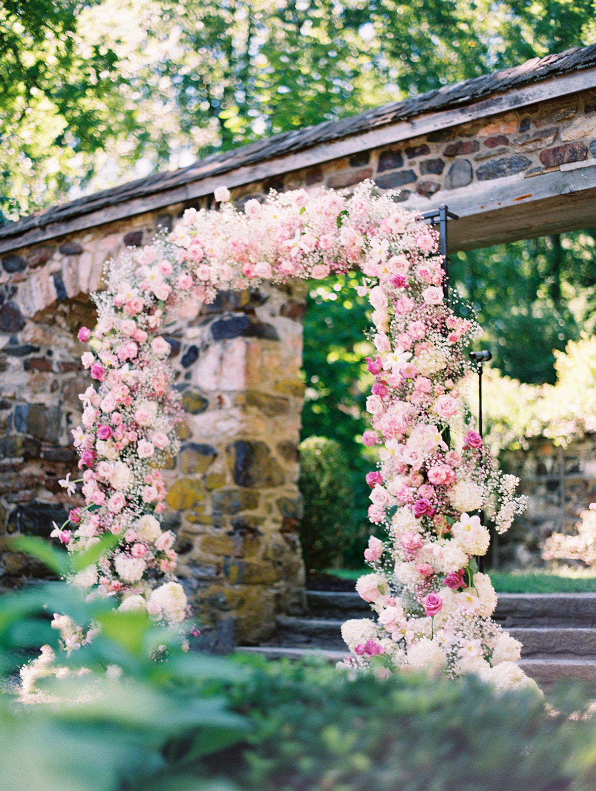 modern pink floral ceremony arch for Timeless Summer Wedding at Parque at Historic Hunting Hill Mansion