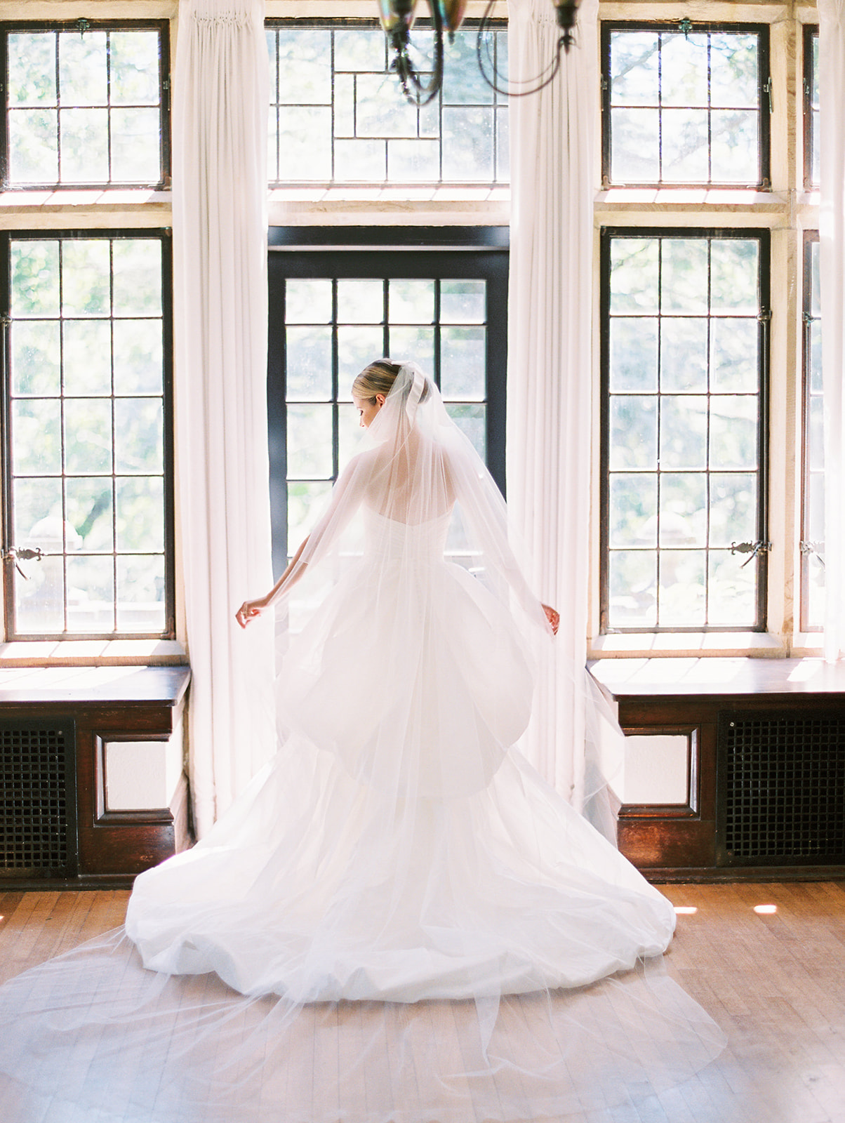 traditional bride shows off long cathedral veil for Timeless Summer Wedding at Parque at Historic Hunting Hill Mansion