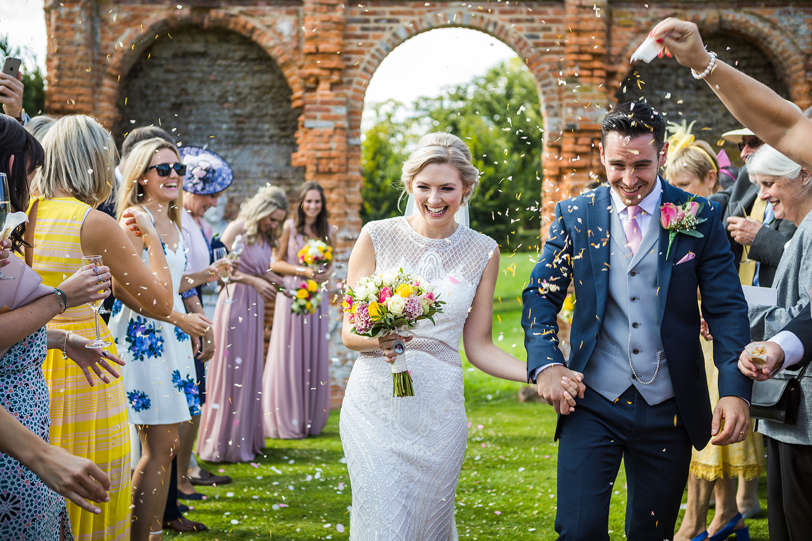 A couple doing a confetti line at Oxnead Hall Norfolk on their wedding day