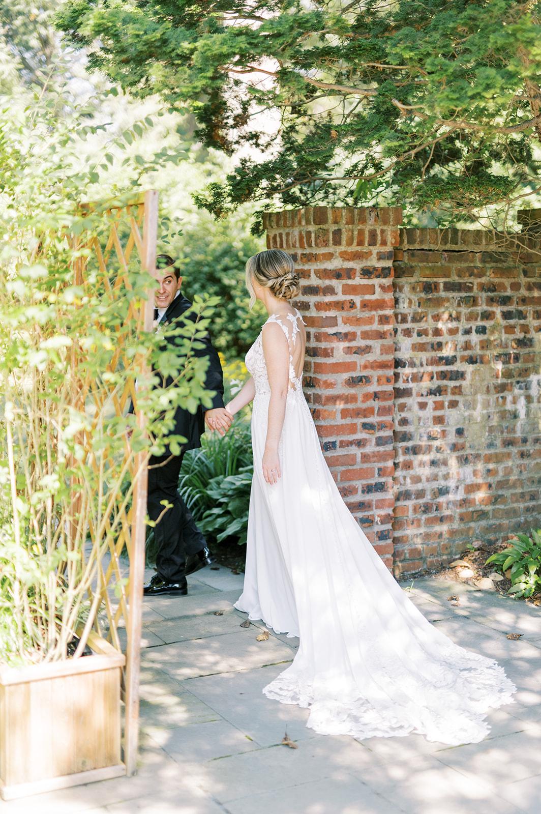 dreaming moment of bride and groom in sunny garden at greenville country club wedding