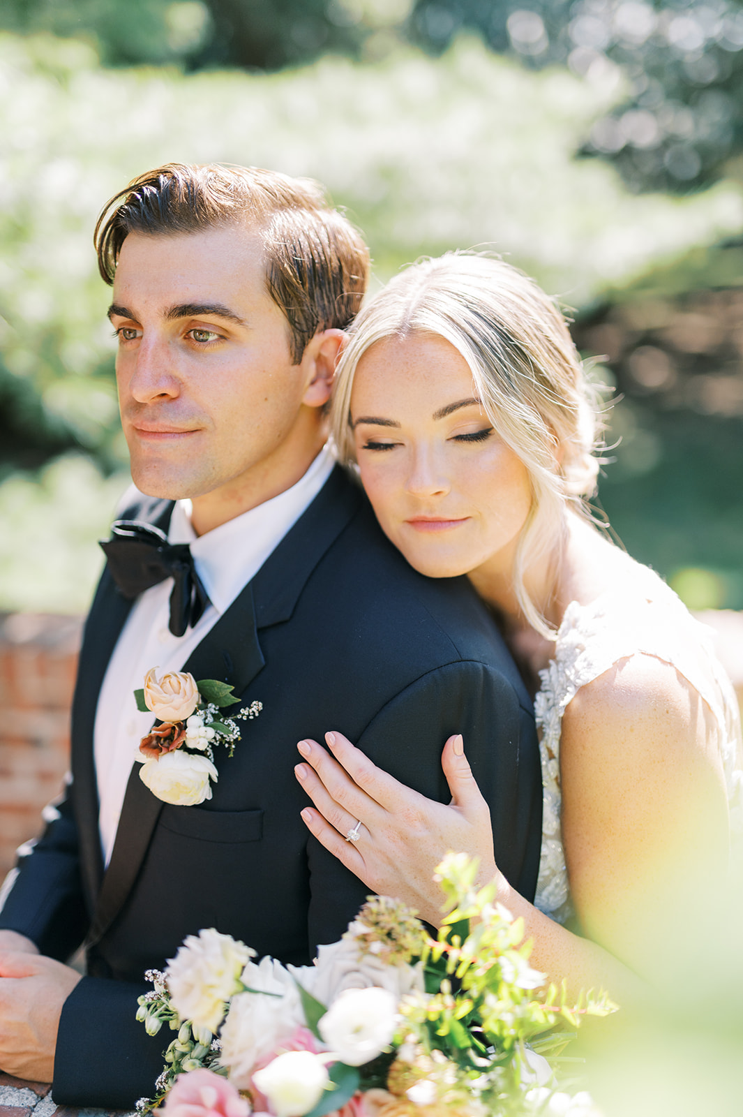 romantic portrait of bride and groom embracing in dreamy sunlight