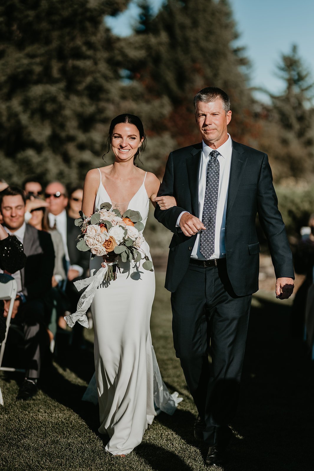 Bride with dad walking down the isle at her Calgary Pinebrook Golf Club wedding