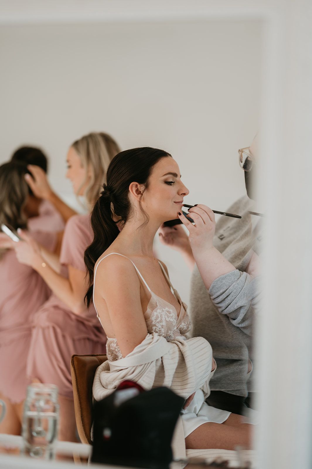 Bride getting her makeup done in the morning of her wedding