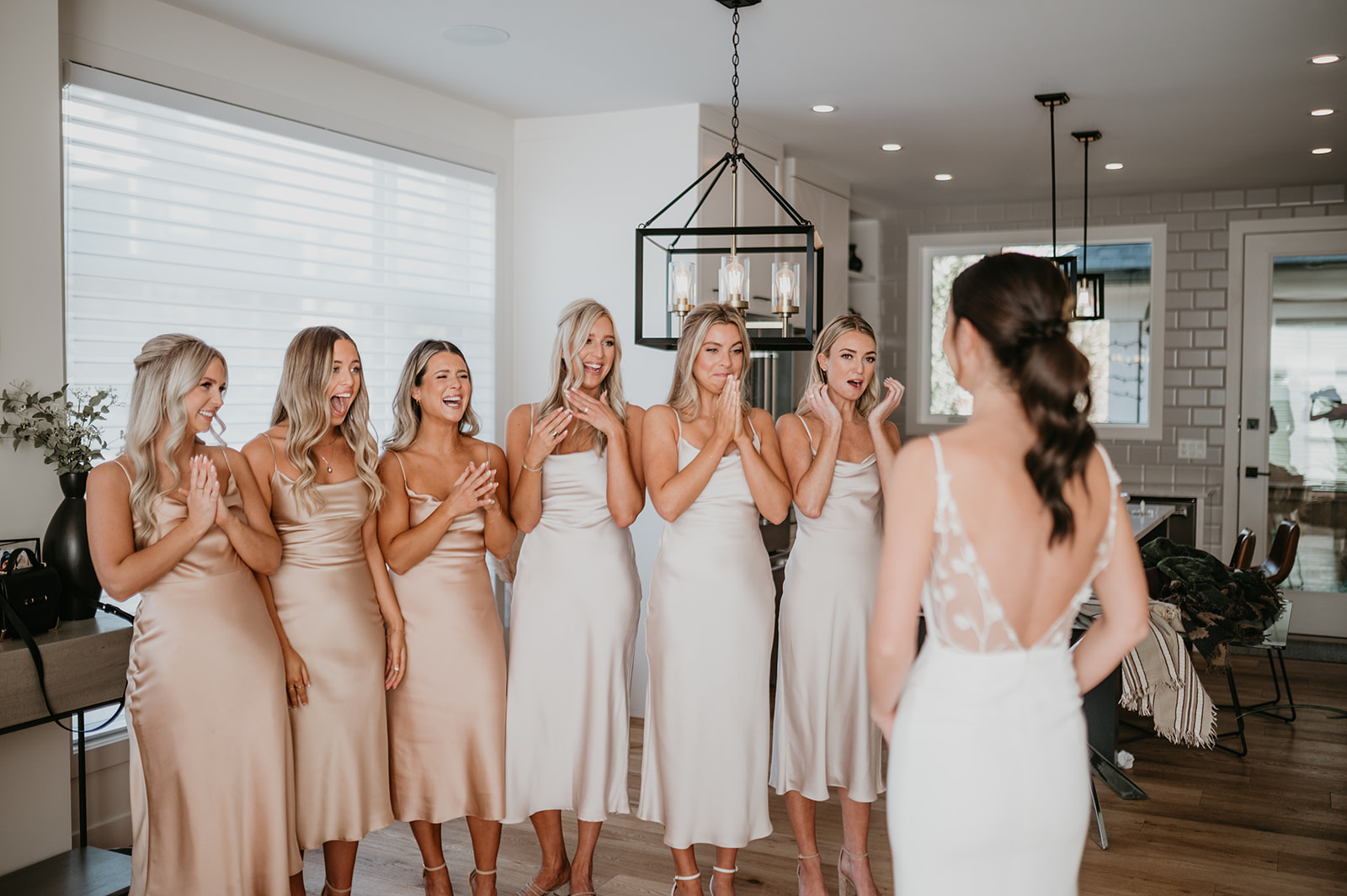 First look with bridesmaids who are wearing park and fifth dresses