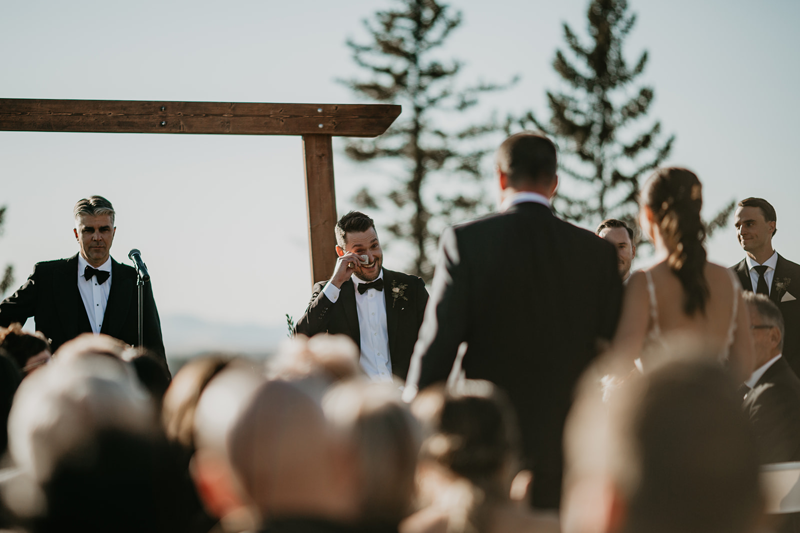 Groom crying as bride walks down the isle at Calgary Pinebrook Golf Club wedding ceremony