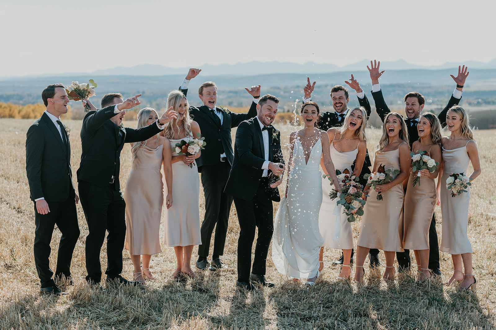 October Calgary Bridal Party popping champagne