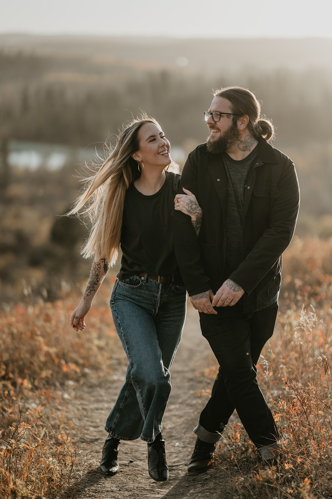 tattoo couple walking laughing during fall in Calgary Alberta