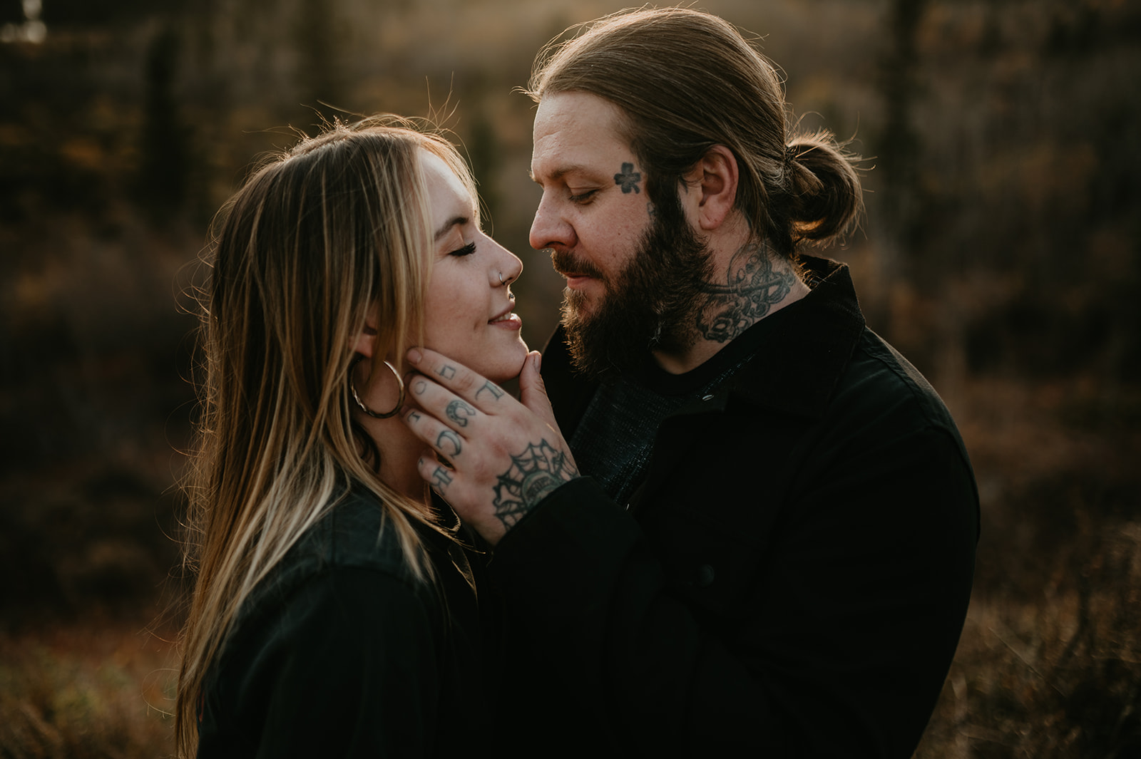 close up of a tattooed couple looking at each other during their couples session in Calgary Alberta