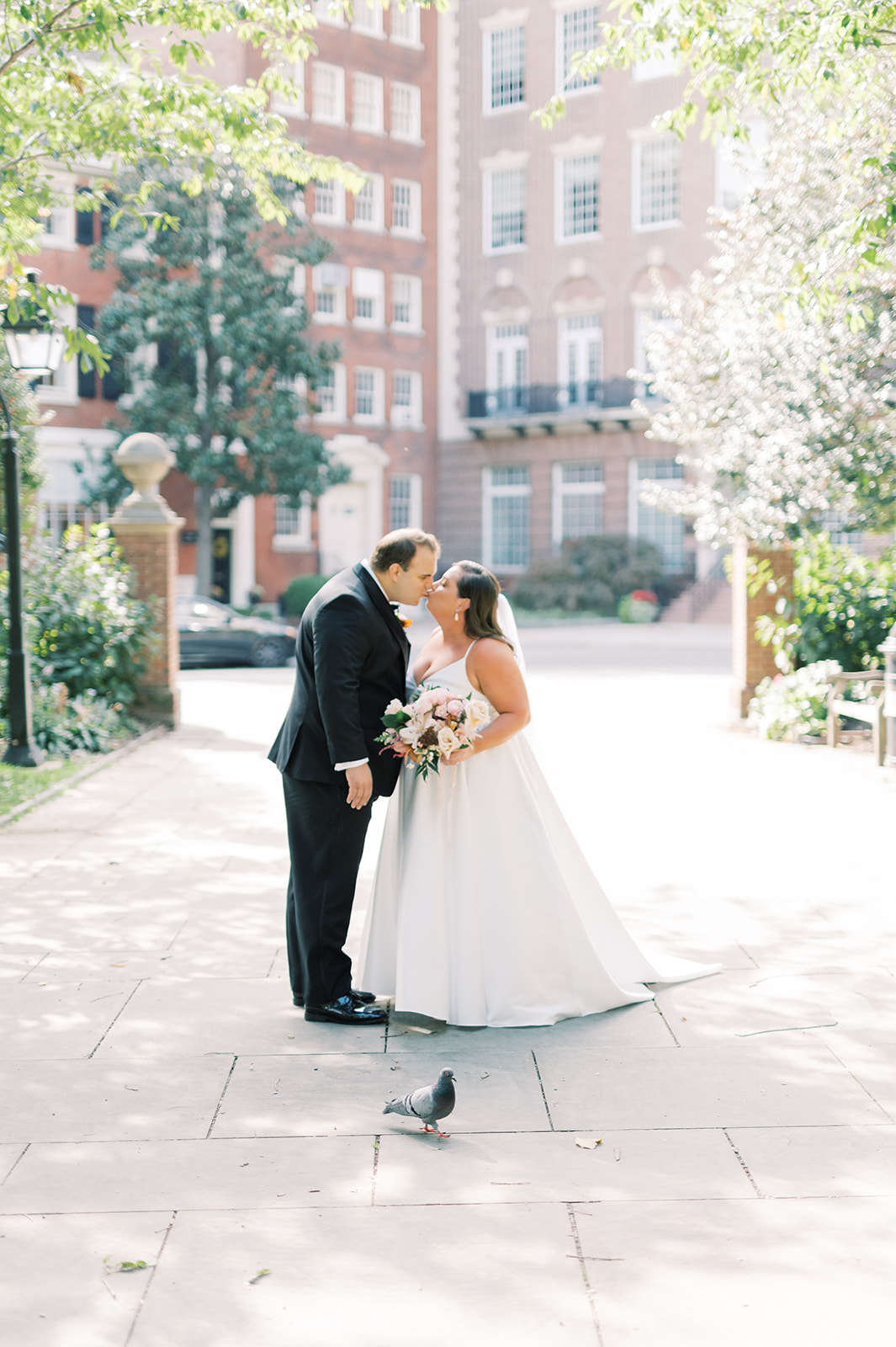 bride and groom kiss at historic washington square park for Classic and Airy AutumnWedding at Philadelphia’s Union Trust