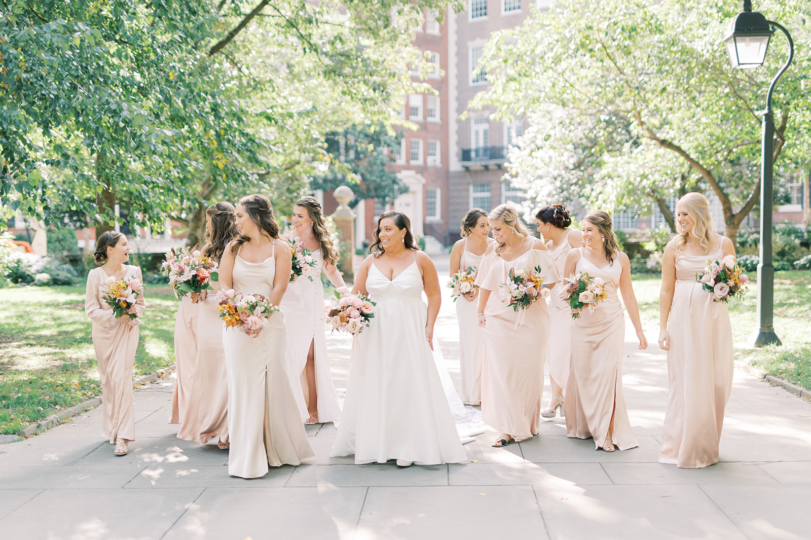 bridesmaids in light pink dresses in washington square park Classic and Airy AutumnWedding at Philadelphia’s Union Trust