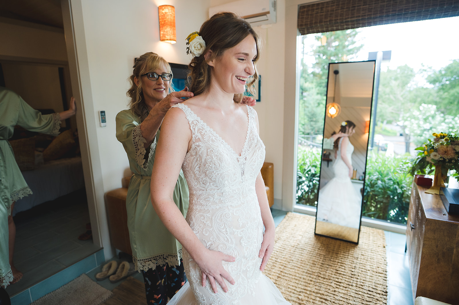 Bridesmaids helping the bride with her stunning wedding gown