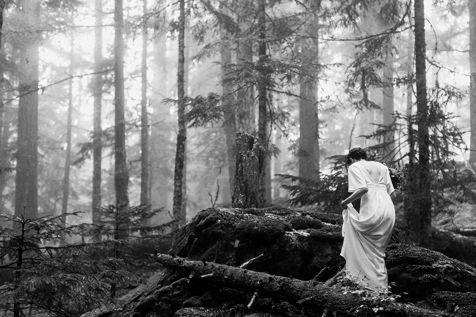 Bride walking though a misty forest in Whistler