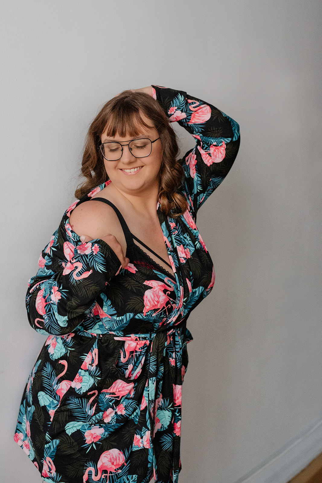 A woman wearing a silk robe during her boudoir photo session