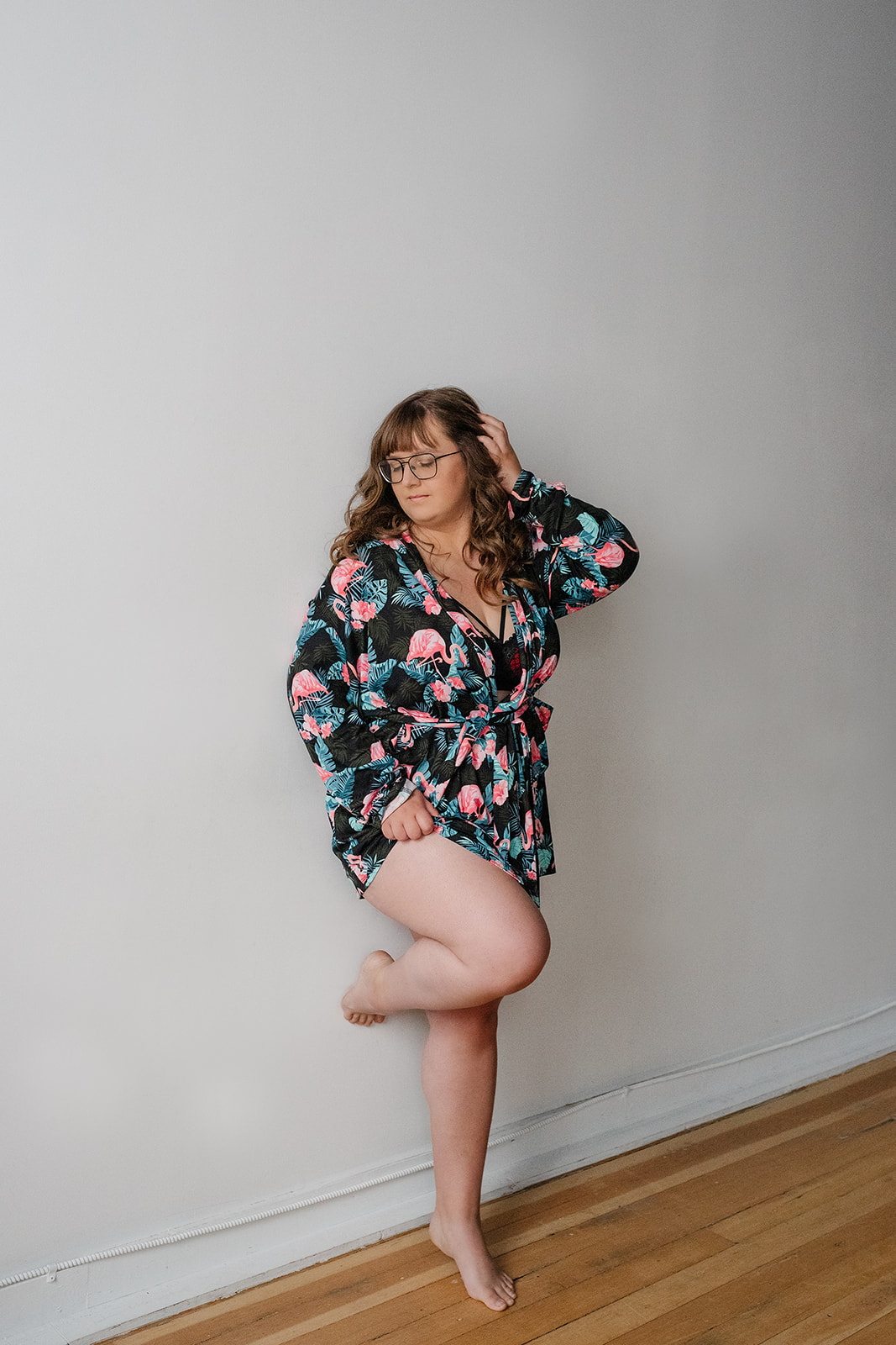 A woman wearing a silk robe during her boudoir photo session