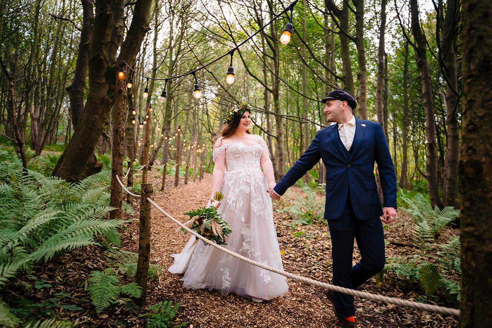 A couple walk hand in hand at  Cockley Wood Weddings