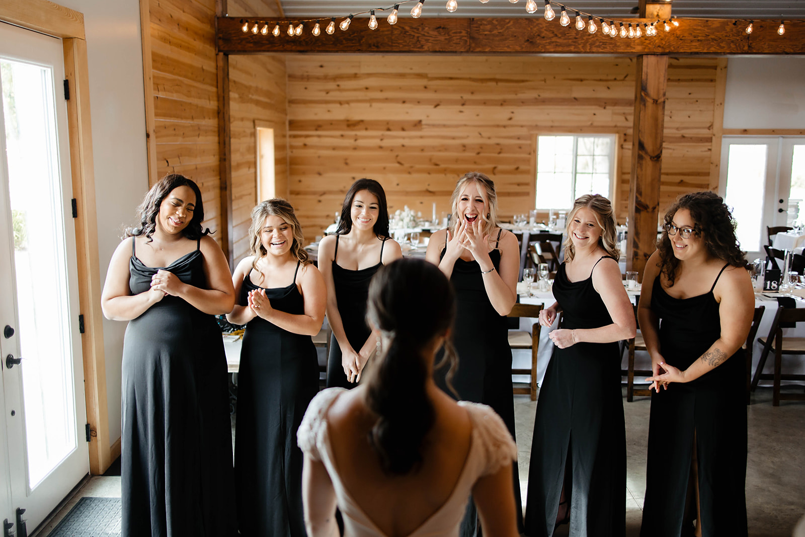 bride revealing her dress to her bridesmaids | detroit wedding photographer
