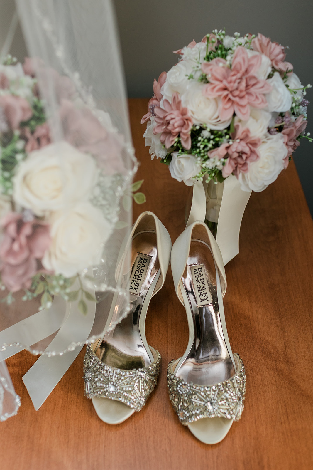 bridal detail photo with shoes, florals and veil