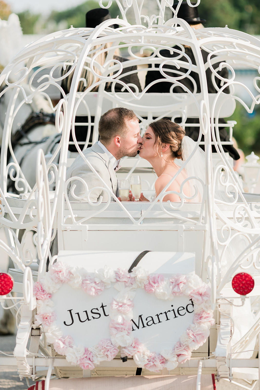 bride and groom kissing in the carriage