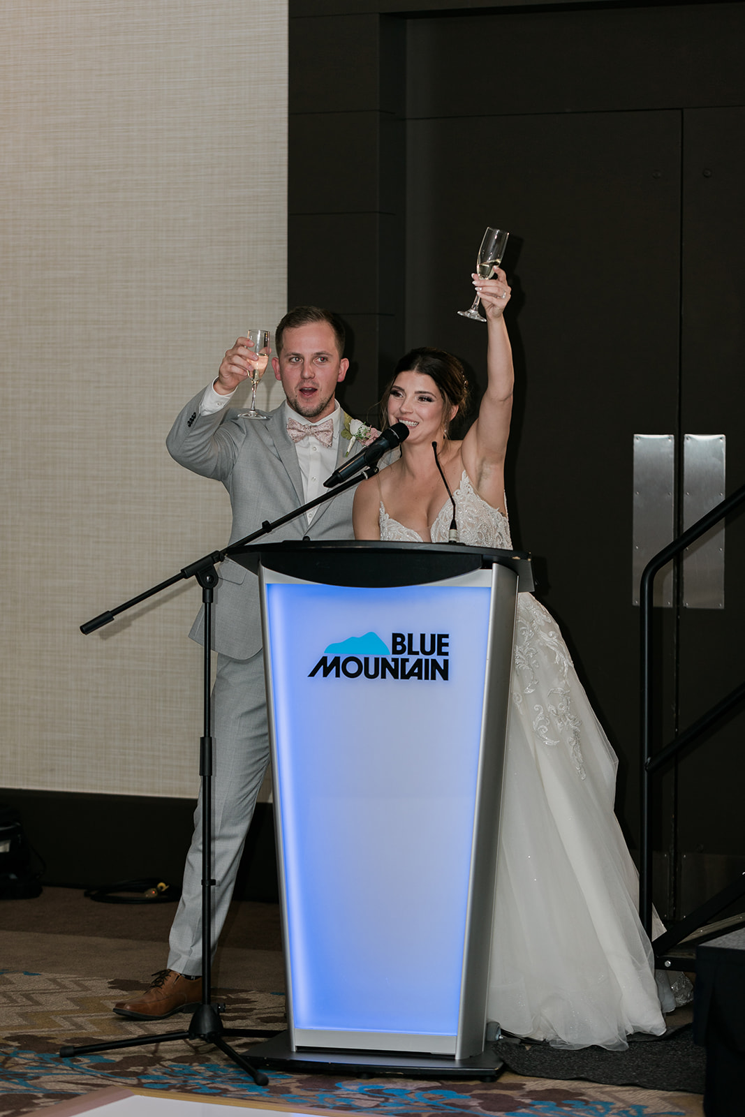 bride and groom raising a toast to their guests
