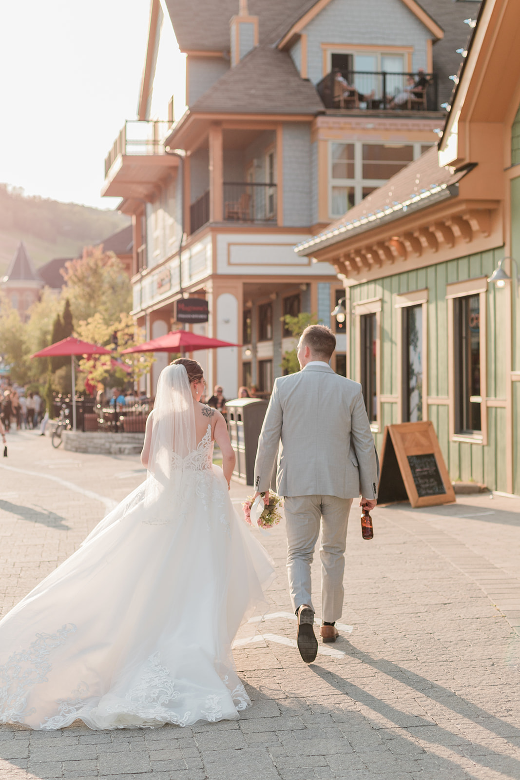 Bride and groom walking at sunset through Blue Mountain Resort