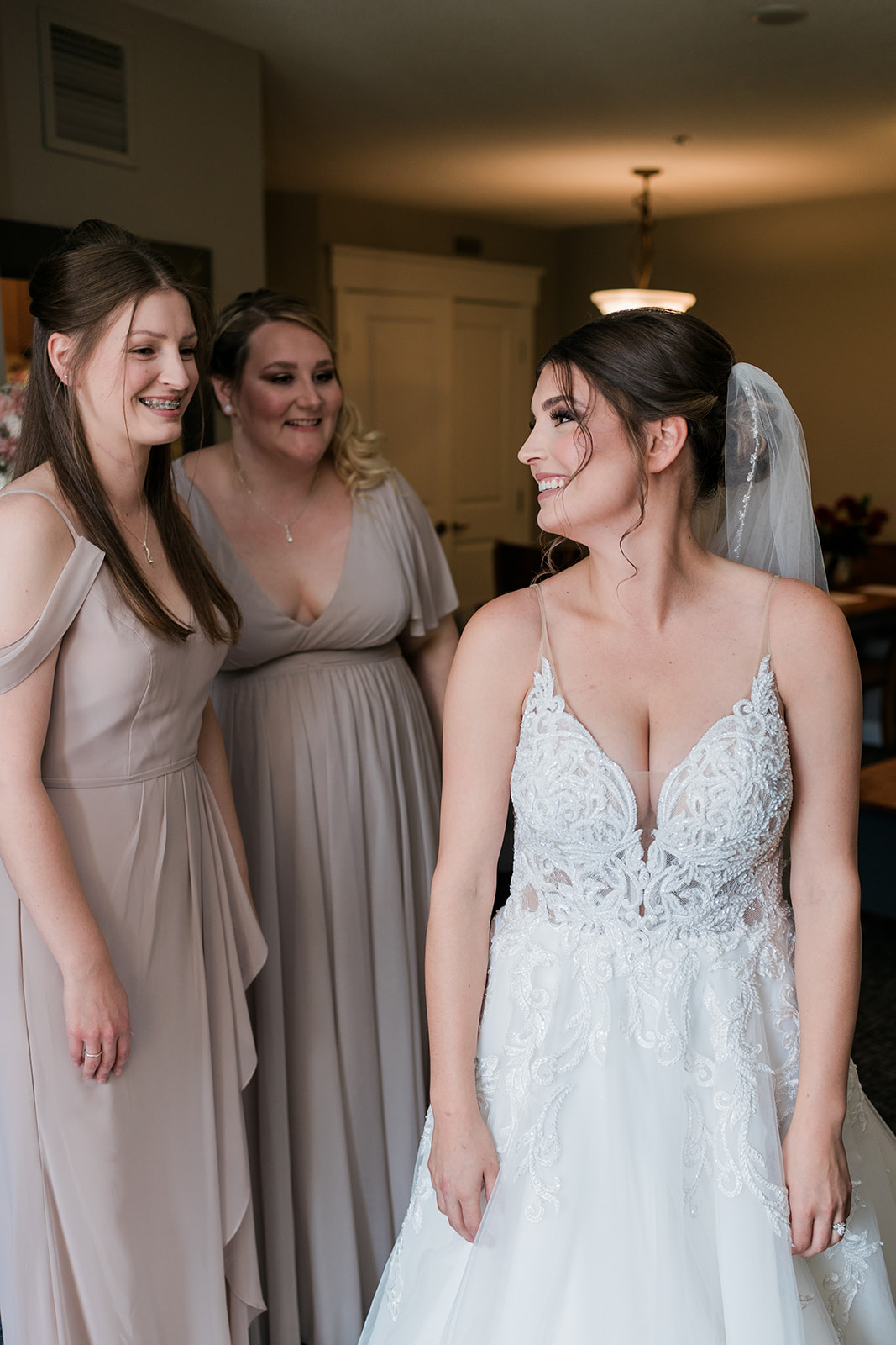 bride looking over shoulder smiling at sister