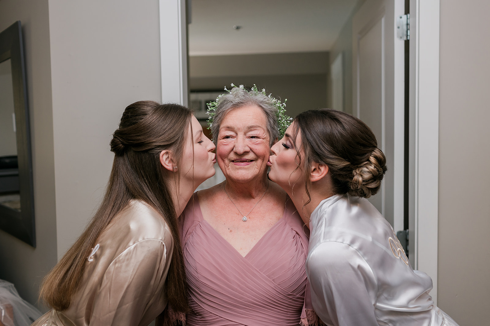 bride and sister kissing Grandma on cheeks