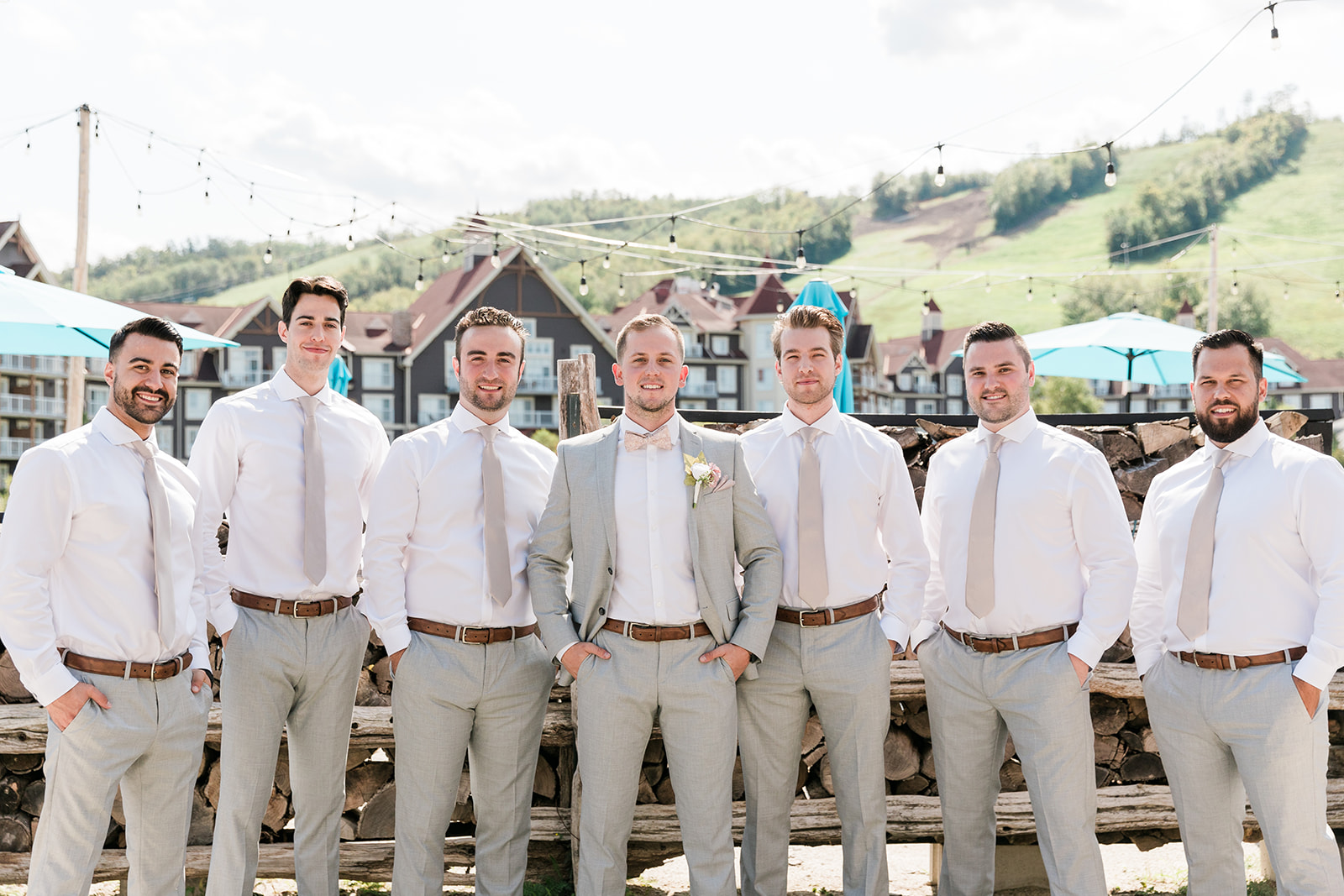 groom and groomsmen in a line with Blue Mountain Resort in the background