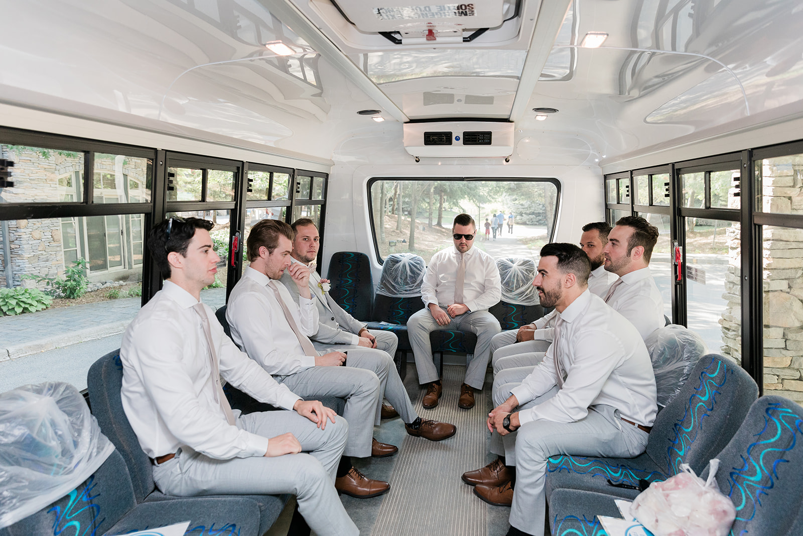 Groom and groomsmen riding in the shuttle