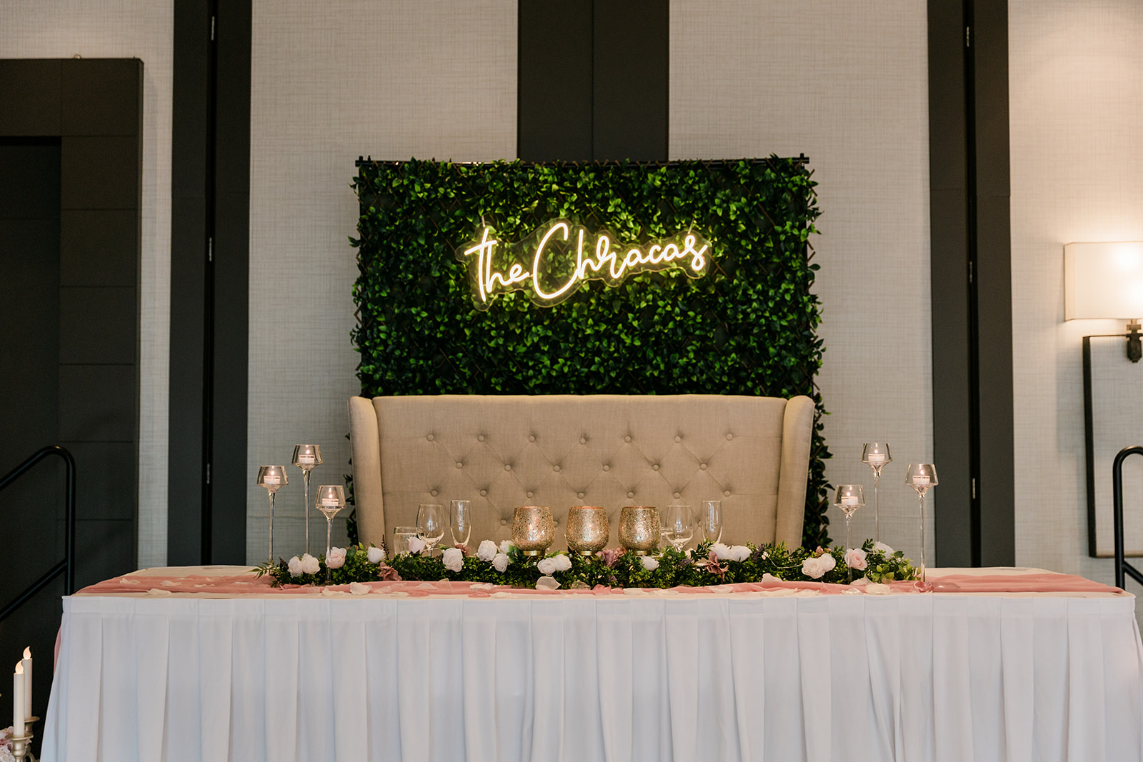 head table during reception with neon sign