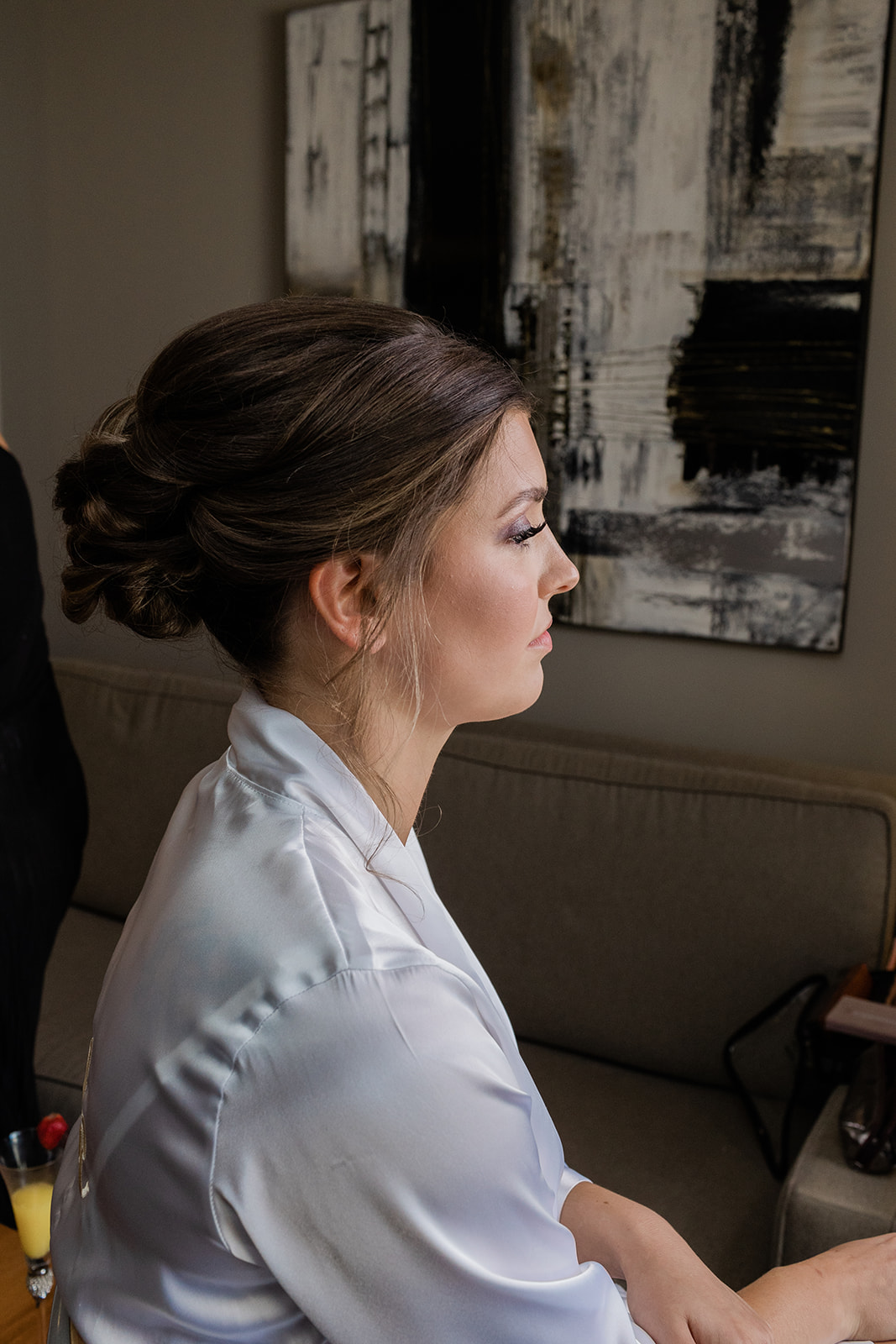 profile of bride getting makeup done