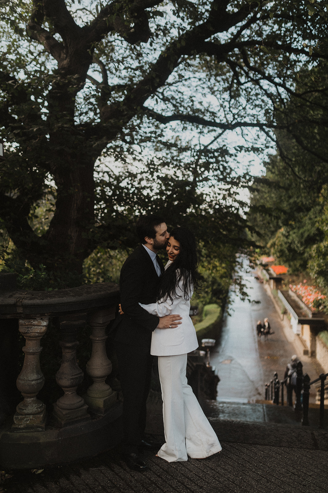 Couple kissing during post-wedding shoot in Princes Street Gardens, Edinburgh