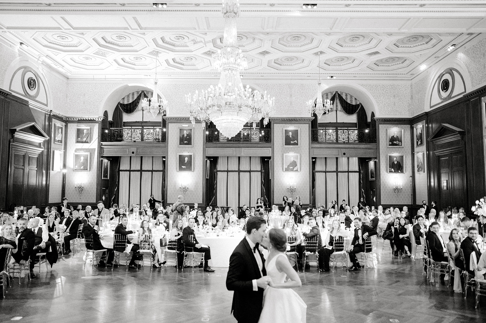 black and white photo of bride and groom kissing first dance grand ballroom at union league of philadelphia wedding