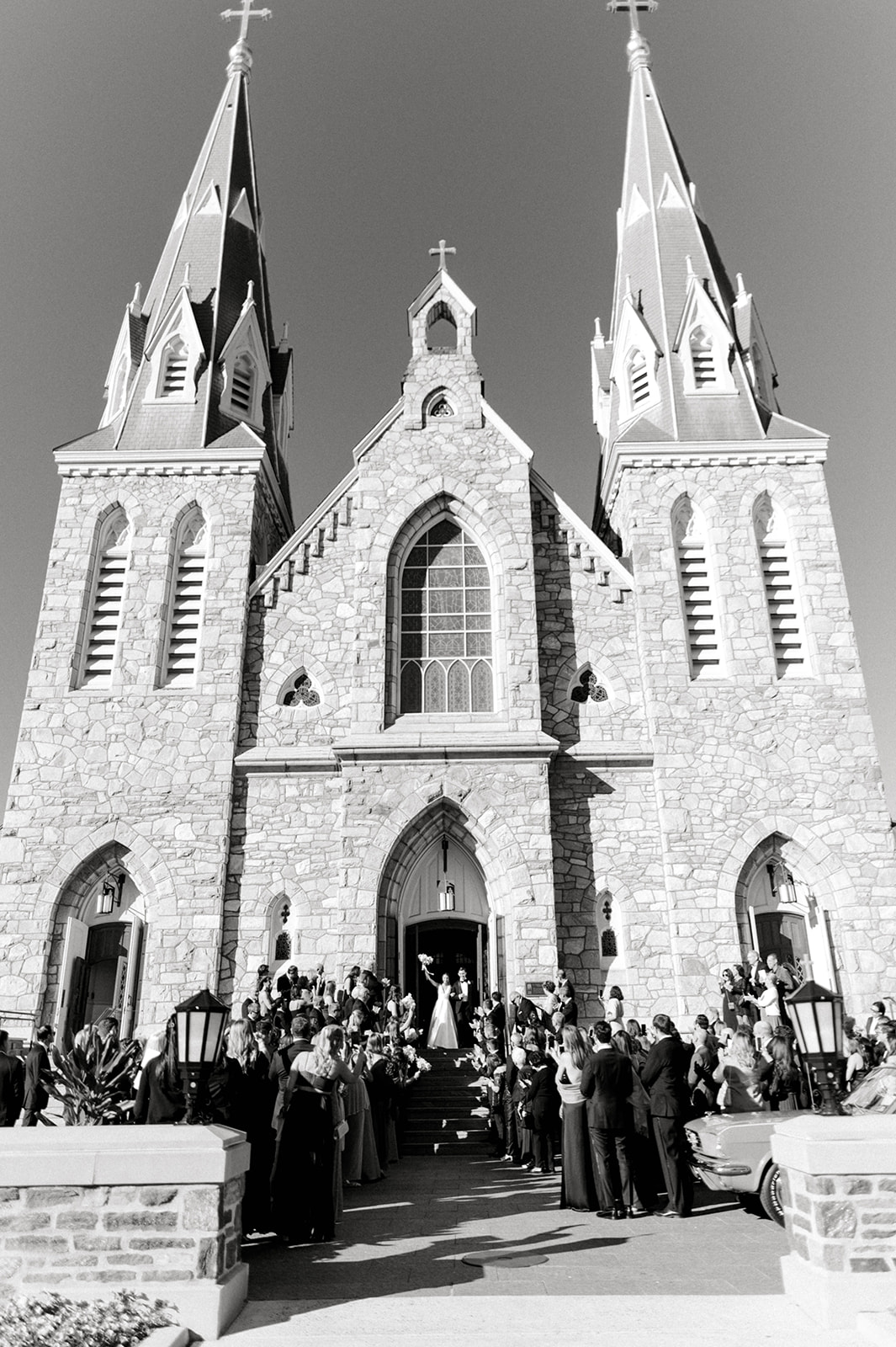 black and white photo of grand ceremony exit of bride and groom at catholic villanova wedding
