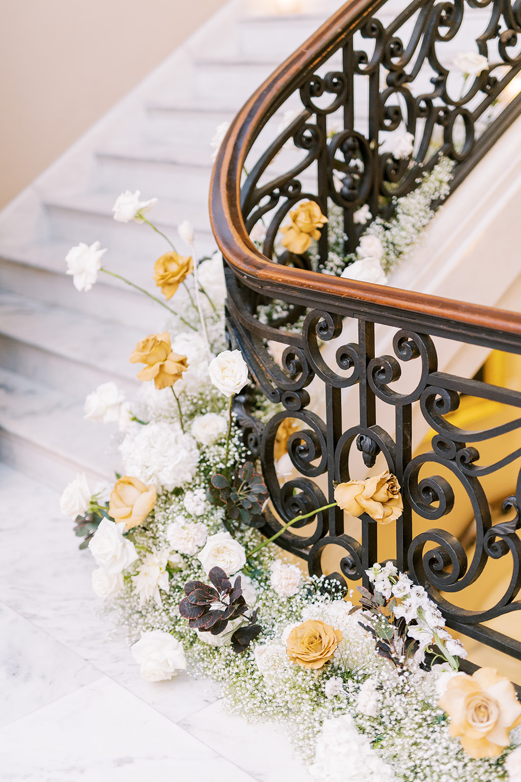 whimsical blooms in white and gold flank the wrought iron railing of the Union League of Philadelphia marble steps