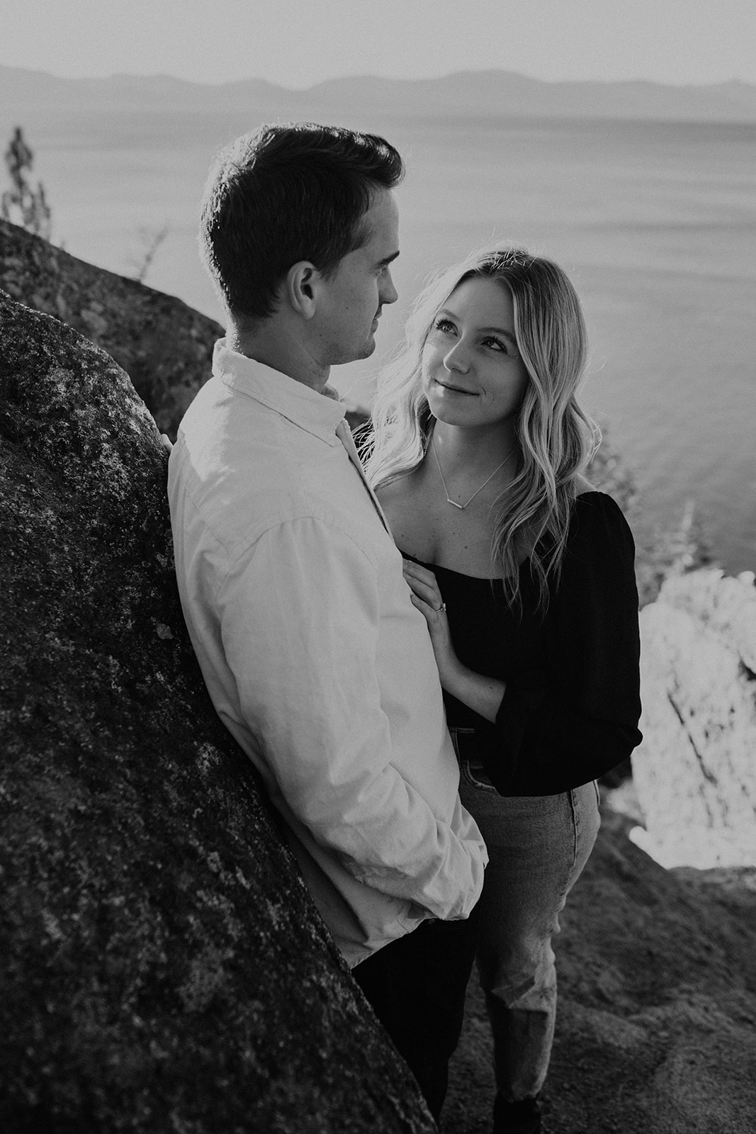 Black and white photo of couple looking at one another
