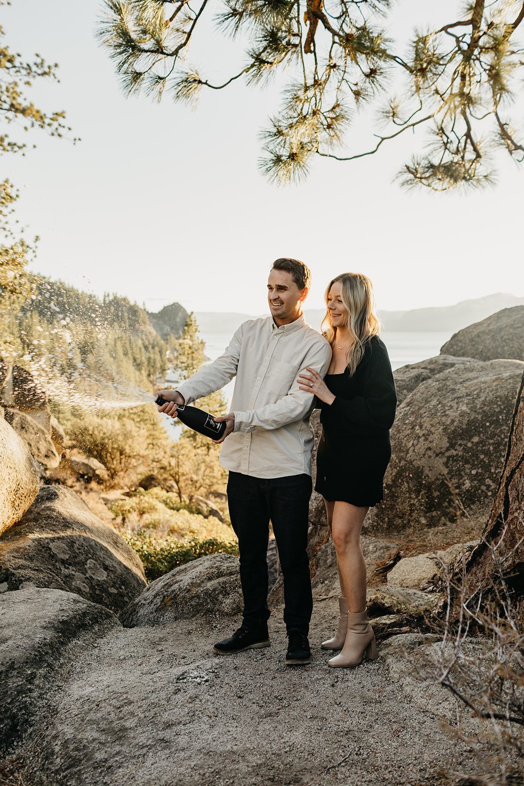 Couple pops champange in lake tahoe to celebrate their engagement 