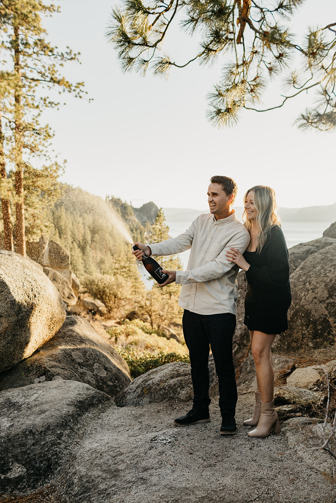 Couple pops champange in lake tahoe to celebrate their engagement 