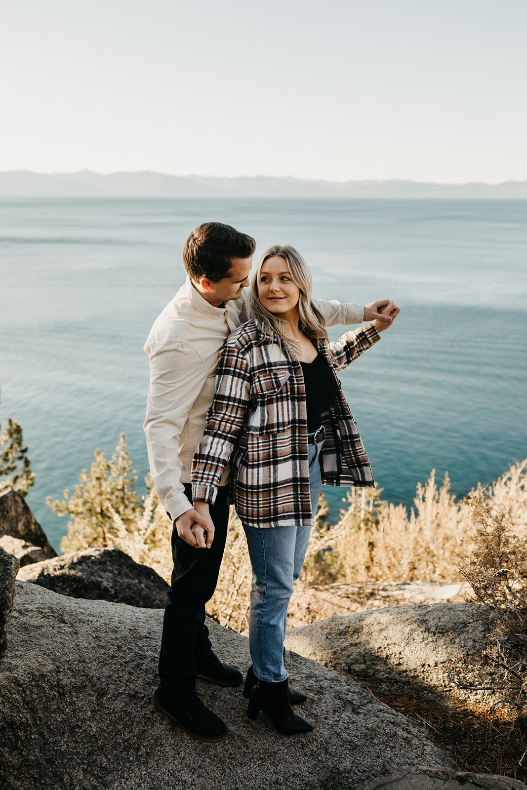 Couple poses with a view of lake tahoe in the background